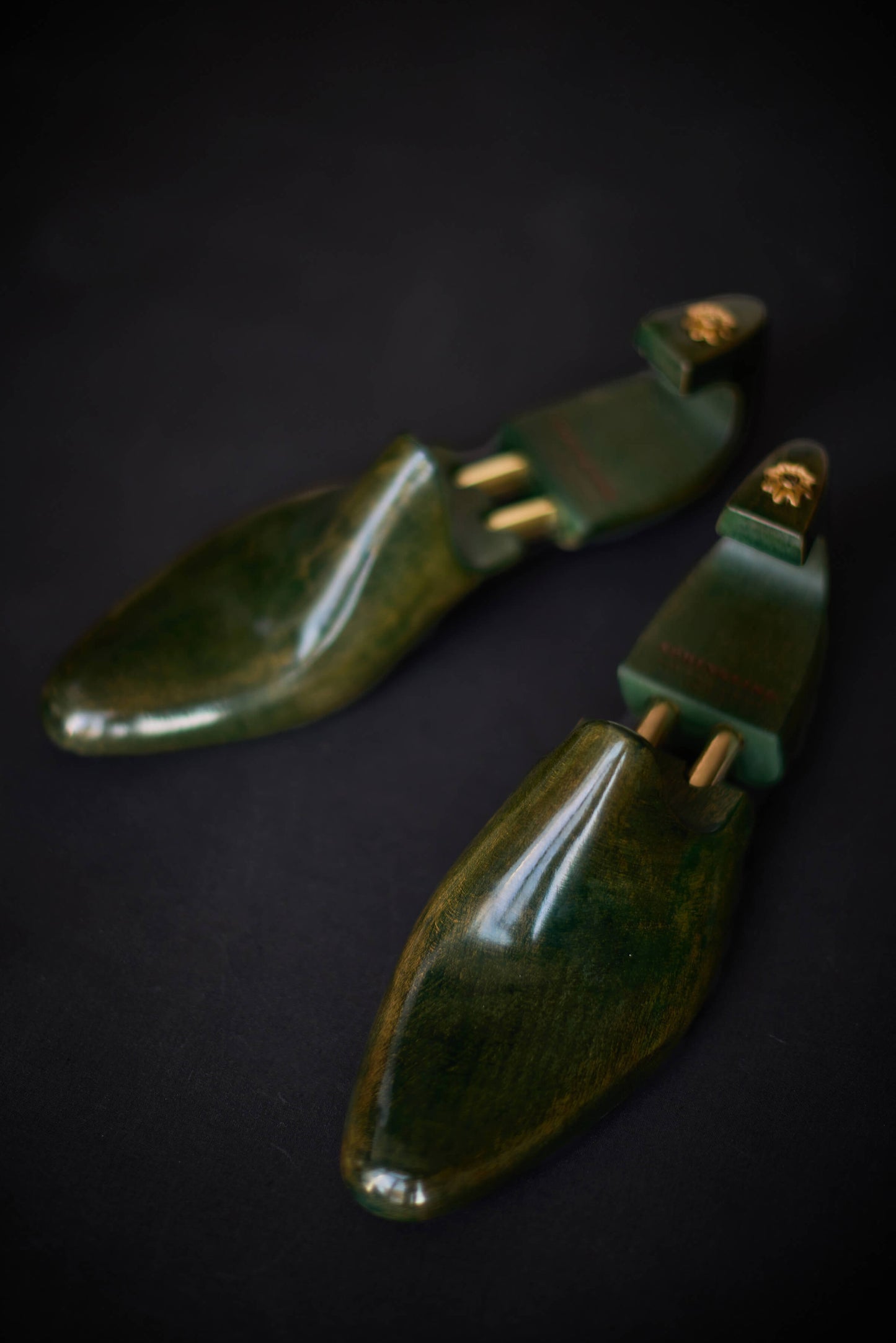 Green Maple shoe trees on a dark background