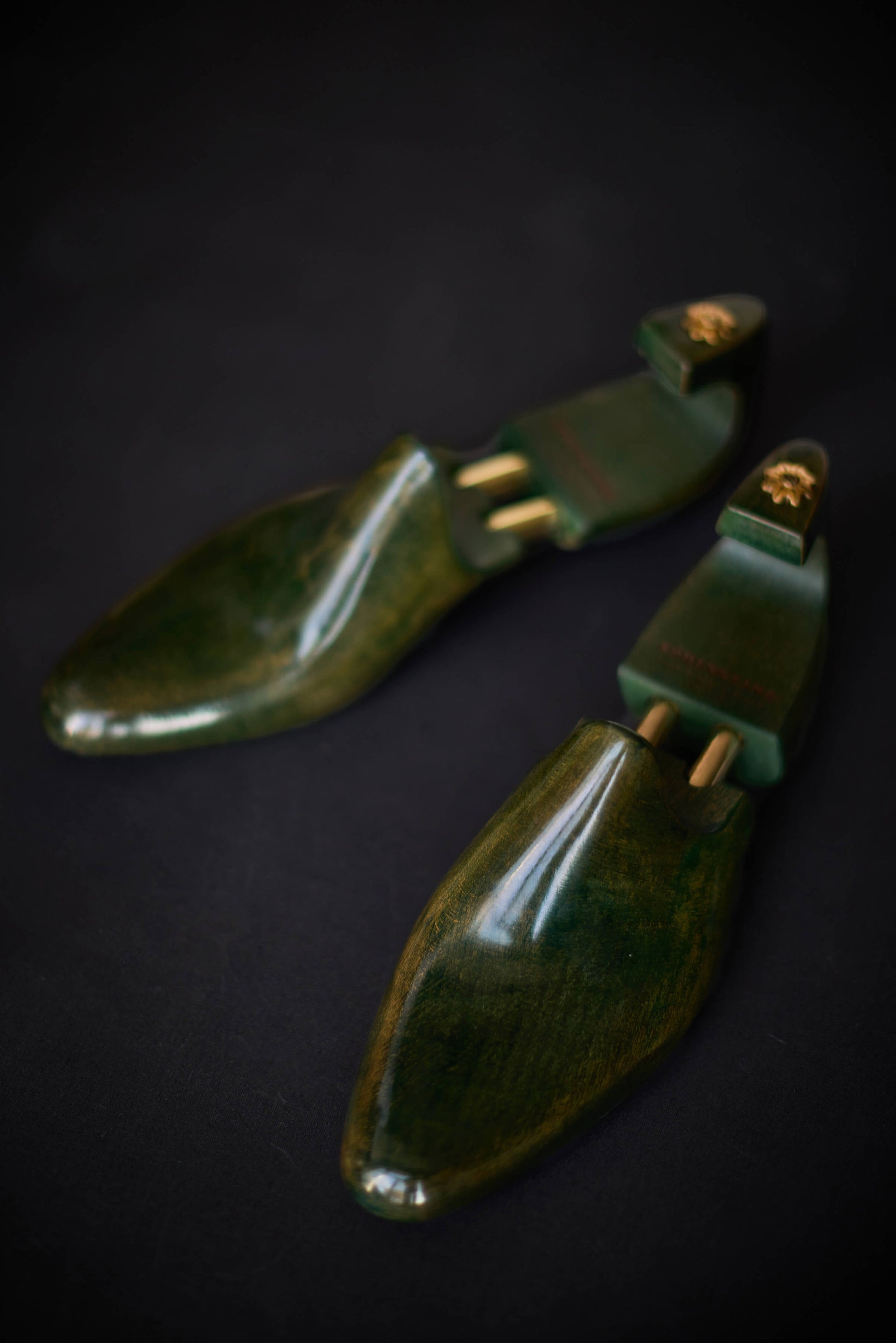Green Maple shoe trees on a dark background