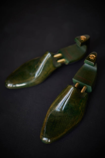Green Maple shoe trees on a dark background
