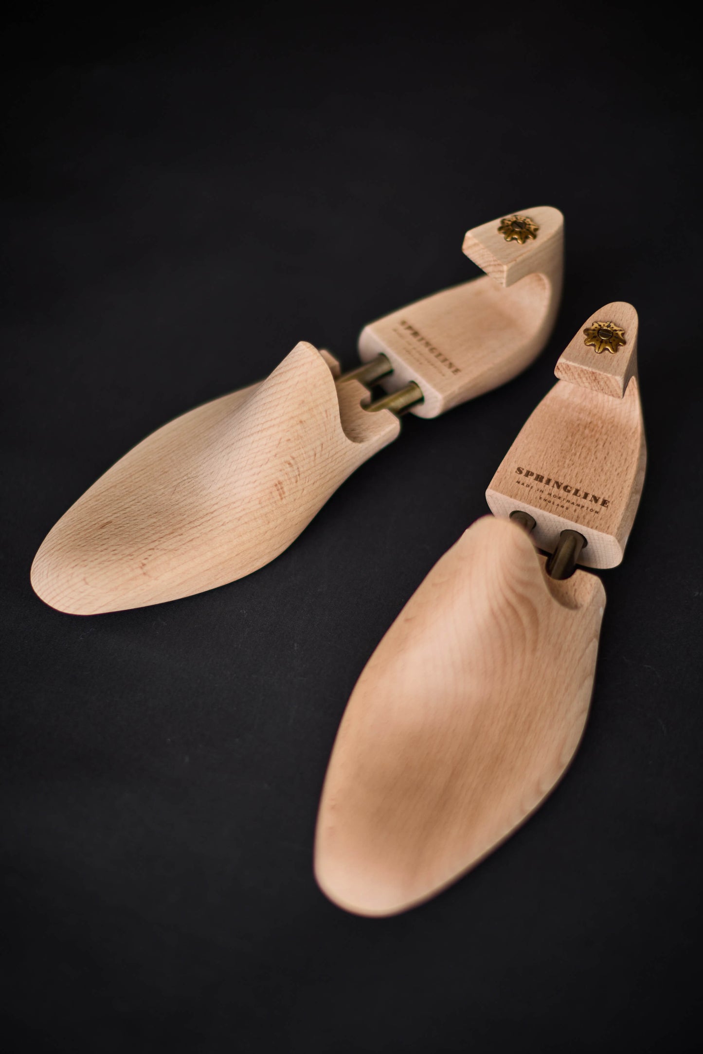 Set of wooden shoe trees on a black background